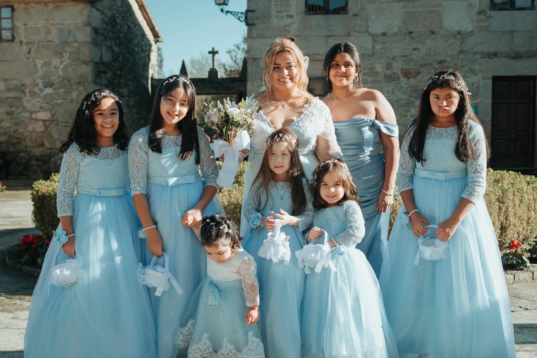 A joyful group of bridesmaids in blue dresses and a bride at a wedding in Santiago de Compostela.